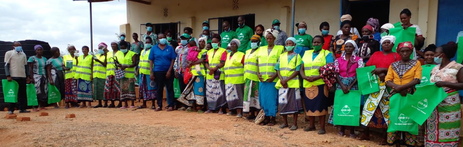 people standing with seed co bags and t shirts
